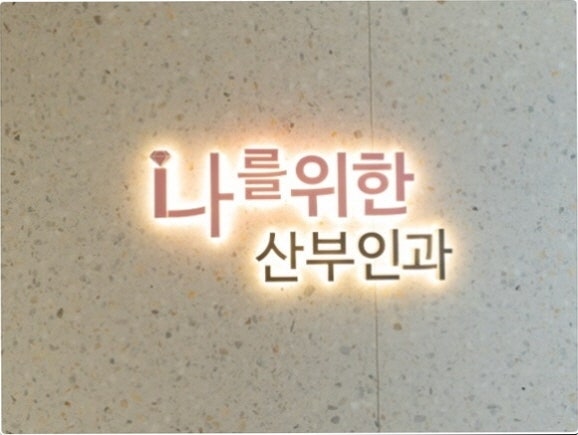 회백색 대리석 벽면에 백라이트로 빛나는 '나를위한 산부인과' 간판 로고 사진